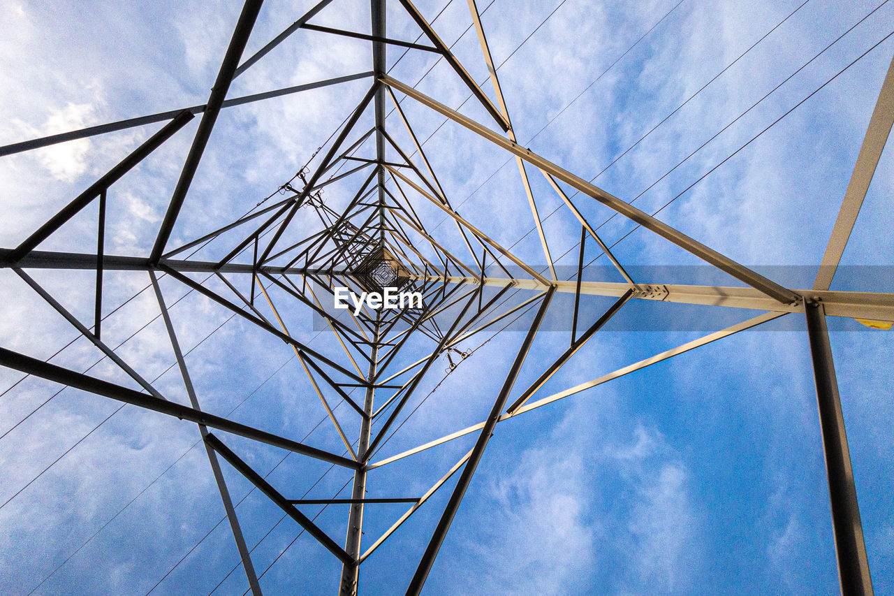 Low angle view of electricity pylon against sky