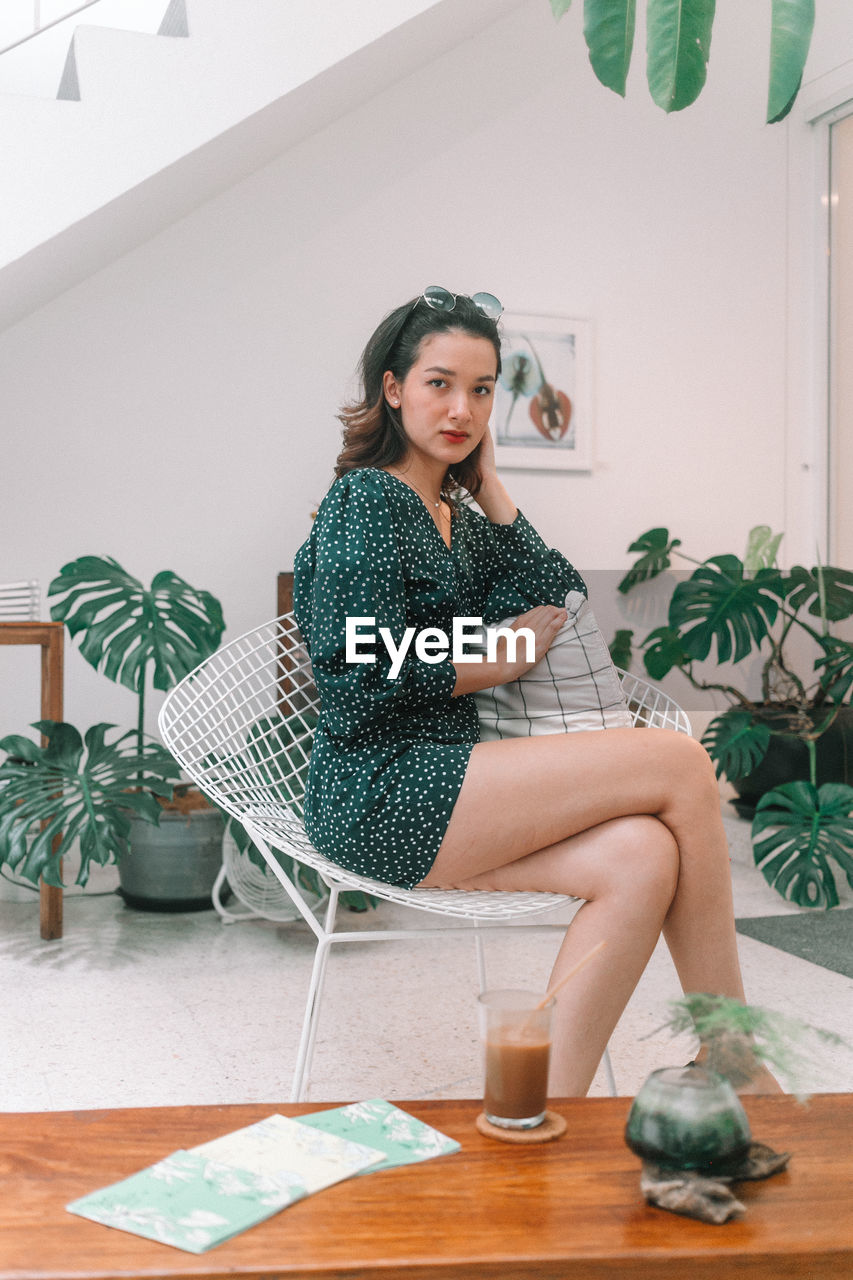 Portrait of woman sitting on table at cafe