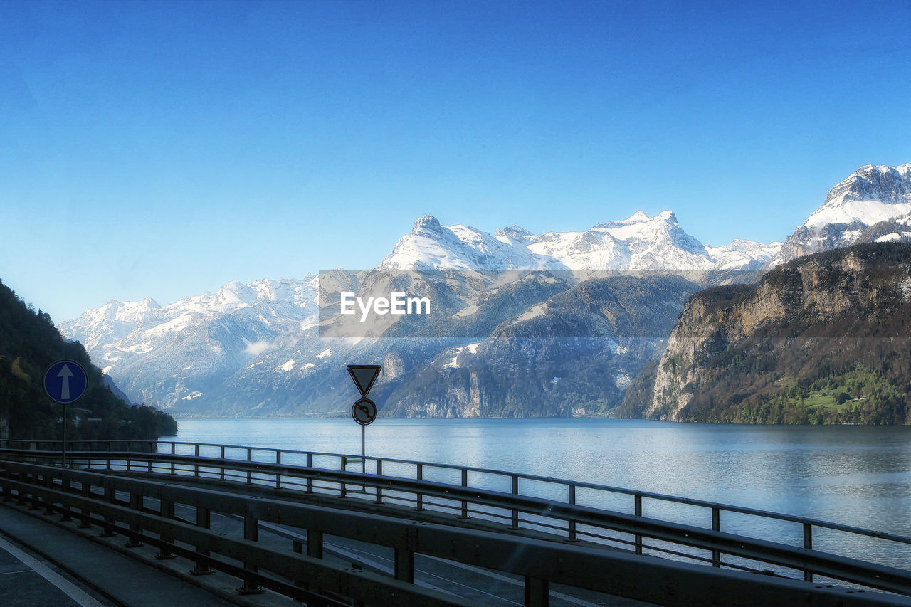 Scenic view of snowcapped mountains against blue sky