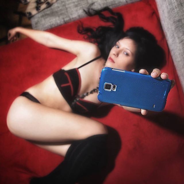 YOUNG WOMAN TAKING SELFIE WITH MOBILE PHONE