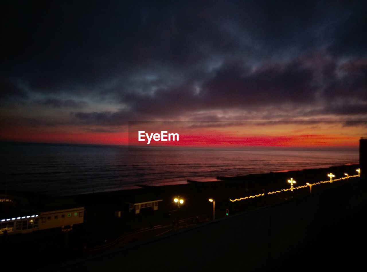 SCENIC VIEW OF SEA AGAINST DRAMATIC SKY DURING SUNSET