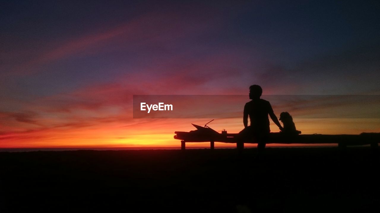 SILHOUETTE OF PEOPLE AT SUNSET