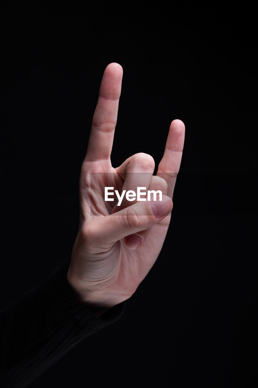 hand, finger, black background, gesturing, studio shot, hand sign, sign language, one person, indoors, communication, adult, black, showing, close-up, arm, cut out, men, thumbs up, success