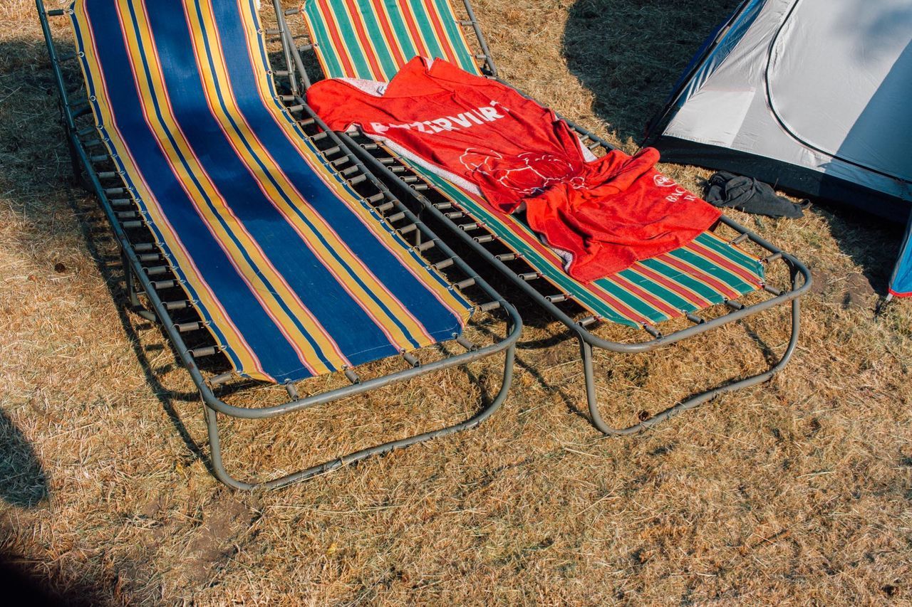 High angle view of lounge chairs on field