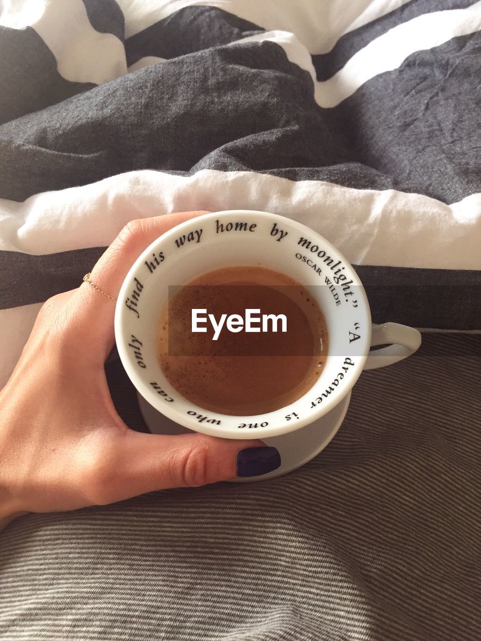 CLOSE-UP OF WOMAN HOLDING CUP OF TEA