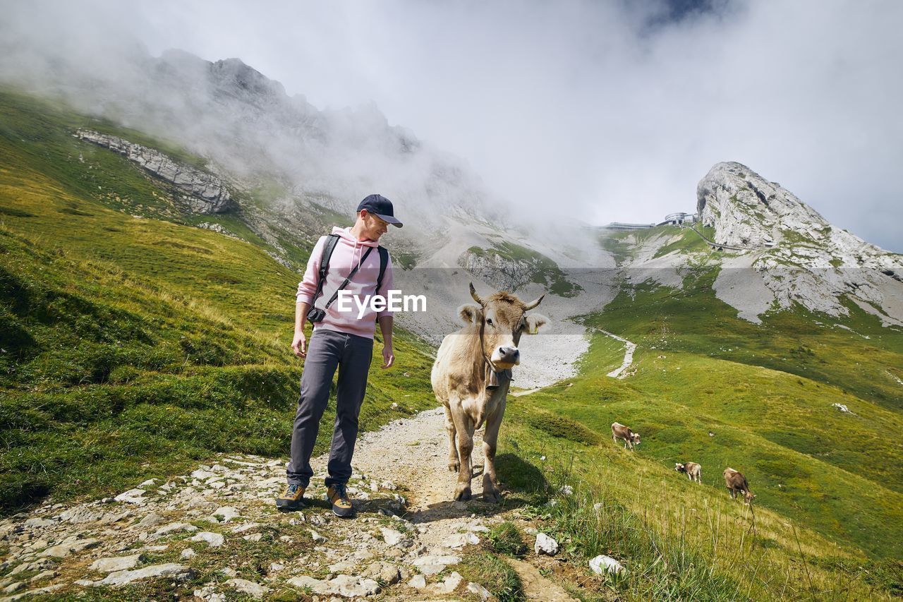 Full length of man standing on mountains