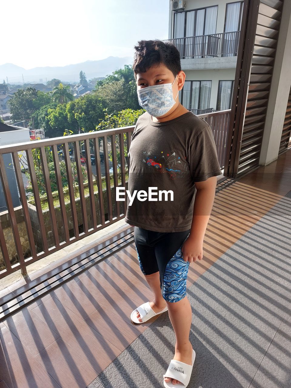 High angle view of boy standing with mask