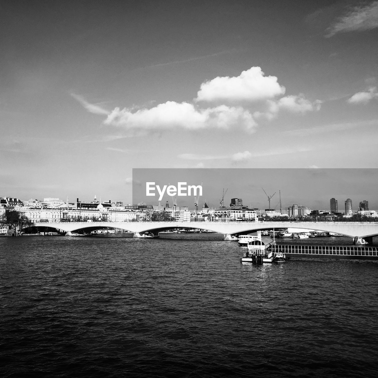 BOATS IN SEA WITH BUILDINGS IN BACKGROUND