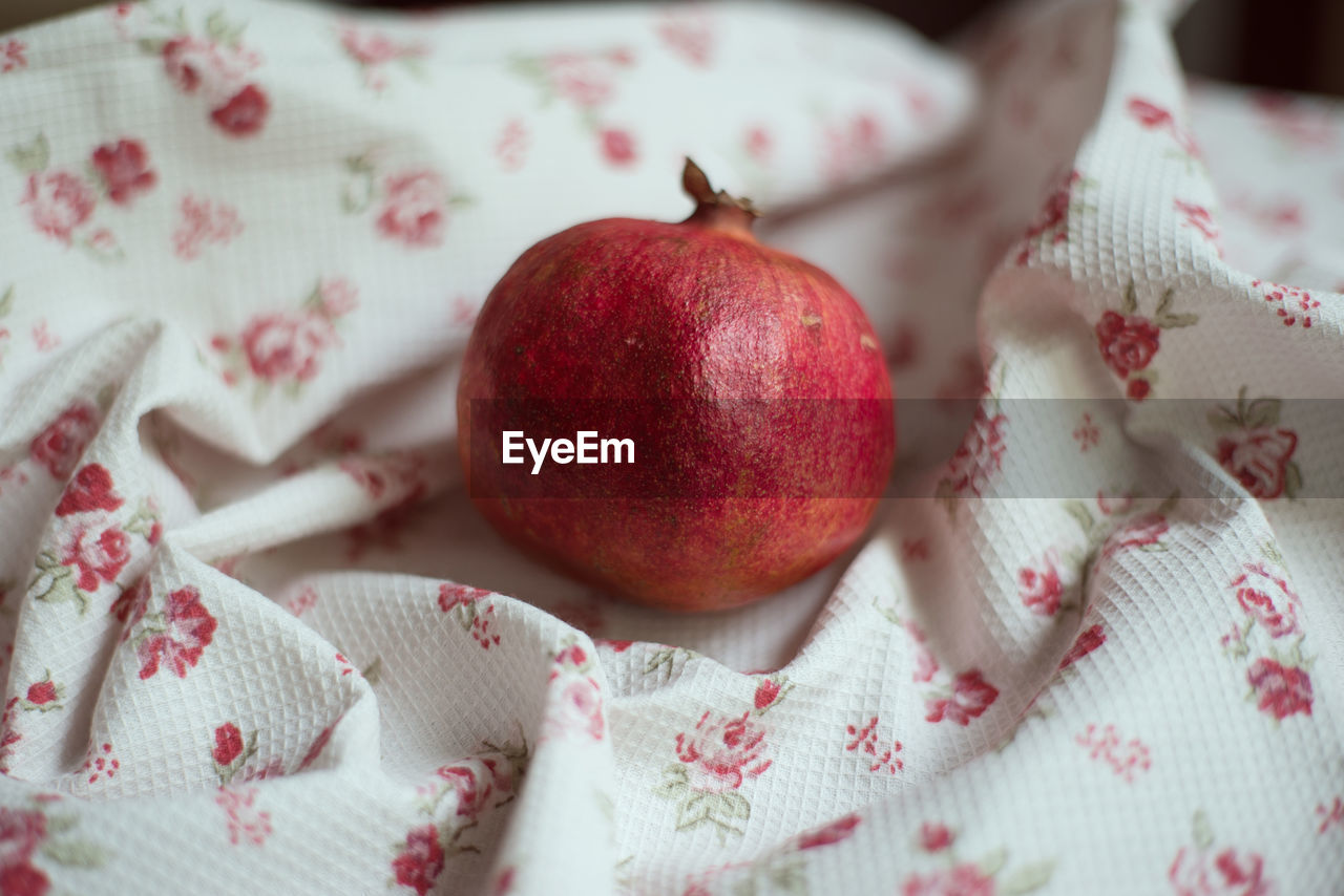 Close-up of pomegranate on textile