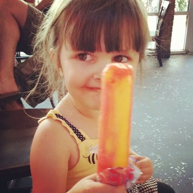 PORTRAIT OF CUTE GIRL HOLDING ICE CREAM