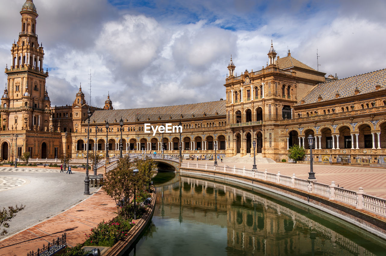 Wide angle on plaza de espana at seville. reflection of building on water in city