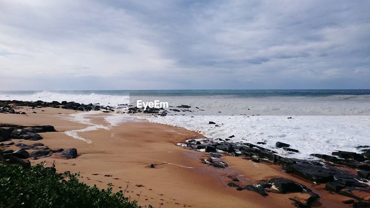 Scenic view of beach against sky