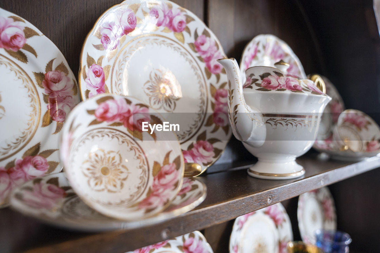 Variety of white plates bowls and tea pots for sale at store
