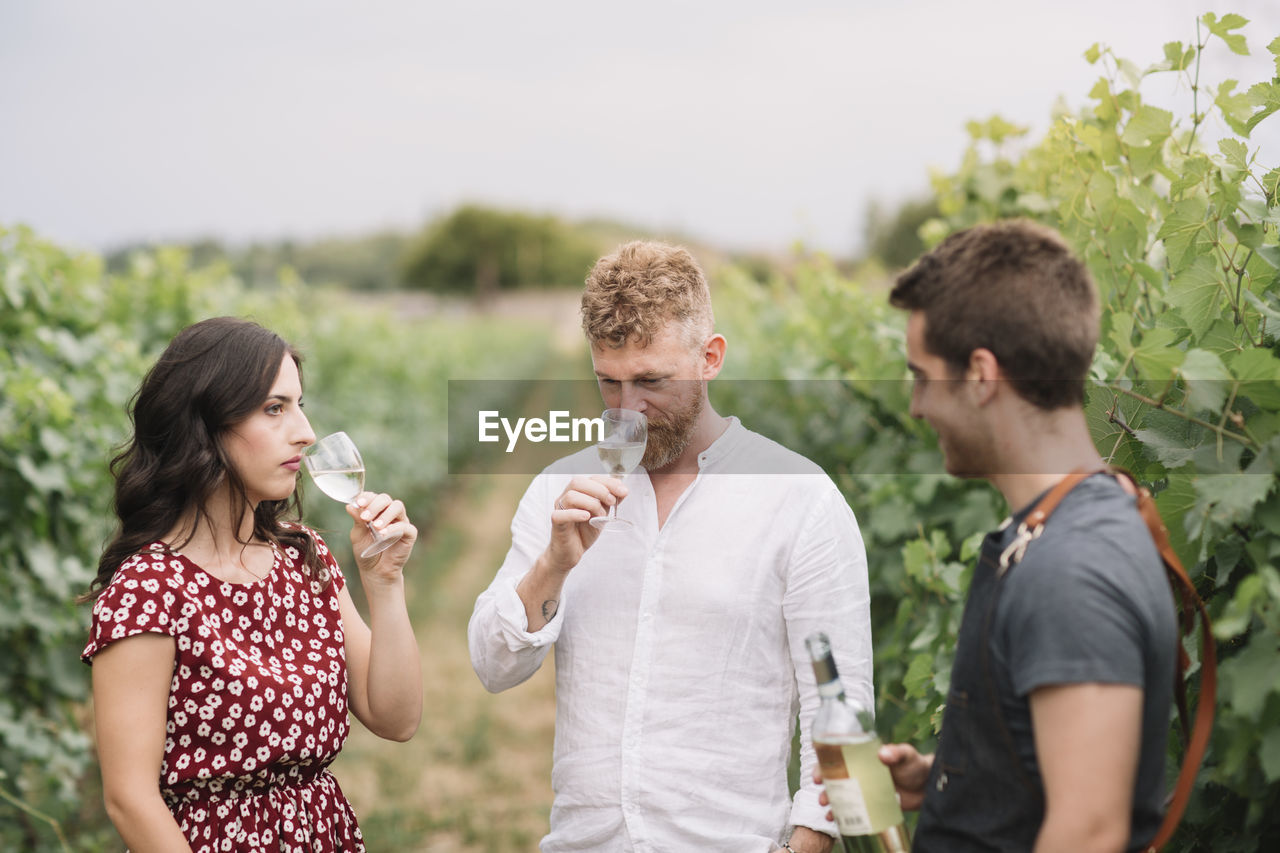 Sommelier explaining customers wine in the vineyard