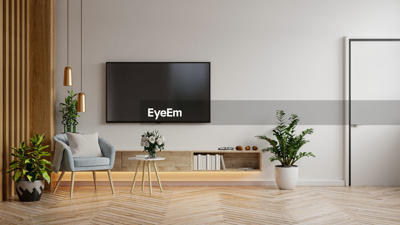 POTTED PLANT ON TABLE AGAINST WALL