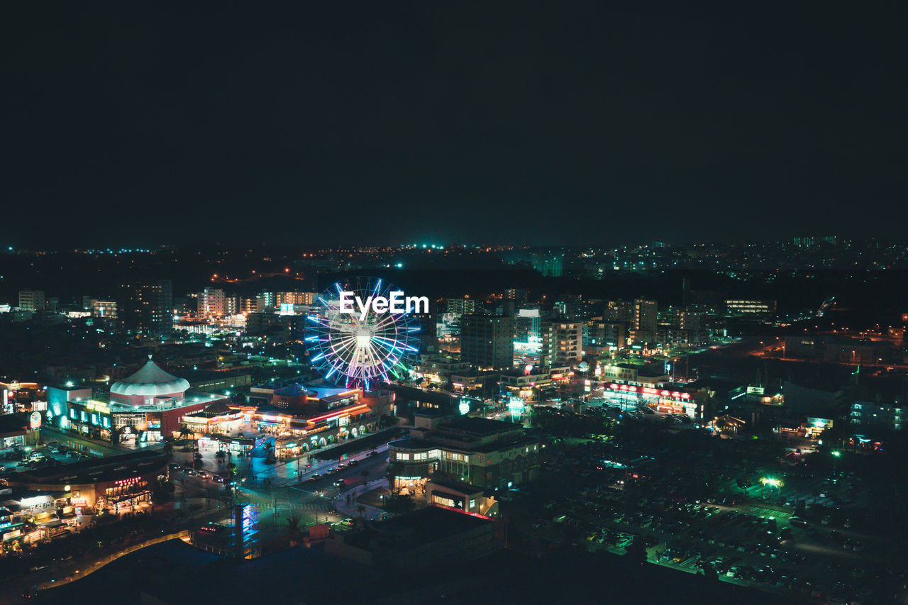 AERIAL VIEW OF ILLUMINATED CITY AT NIGHT