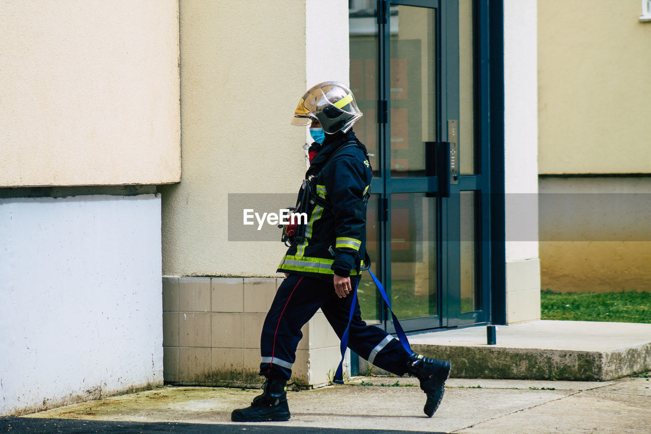 FULL LENGTH OF MAN ON BUILDING WALL