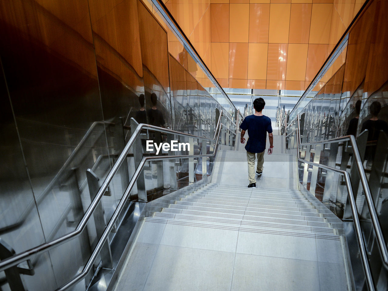 rear view of man walking on staircase