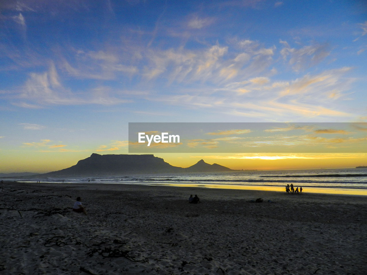 Scenic view of beach against sky during sunset