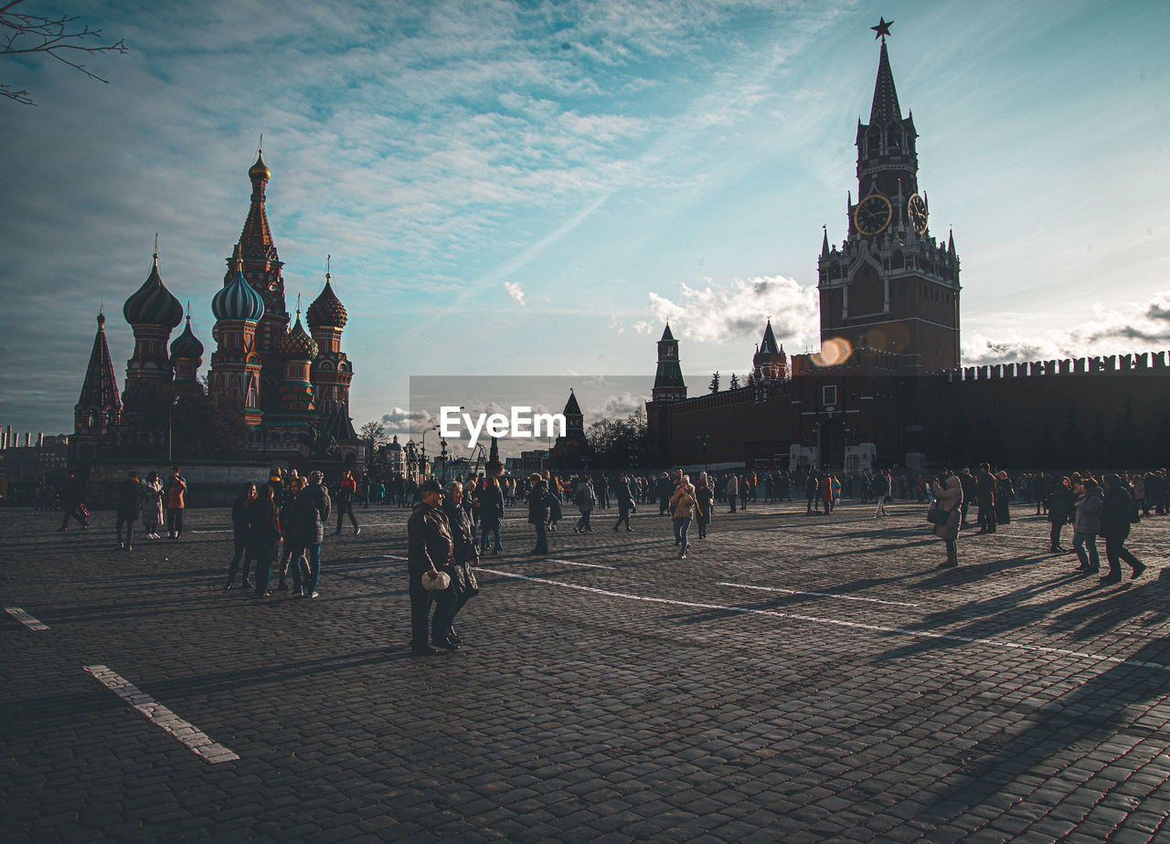 GROUP OF PEOPLE IN FRONT OF BUILDINGS