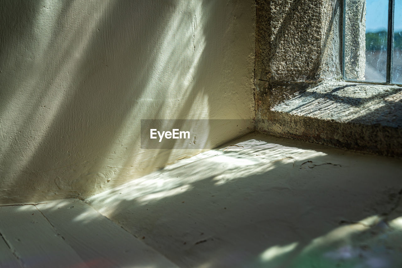 Close-up of sunlight falling on wall in church