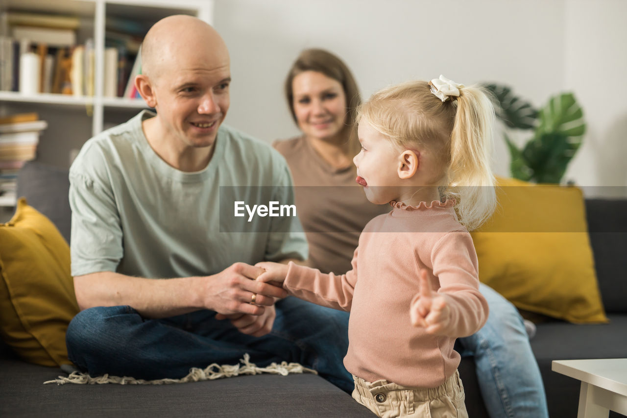 mother and daughter sitting at home