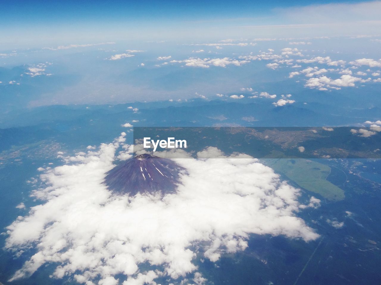 Aerial view of clouds over volcanic mountain peak