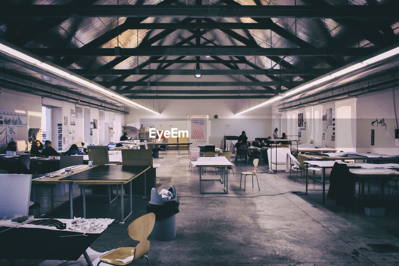 Empty chairs and tables in warehouse