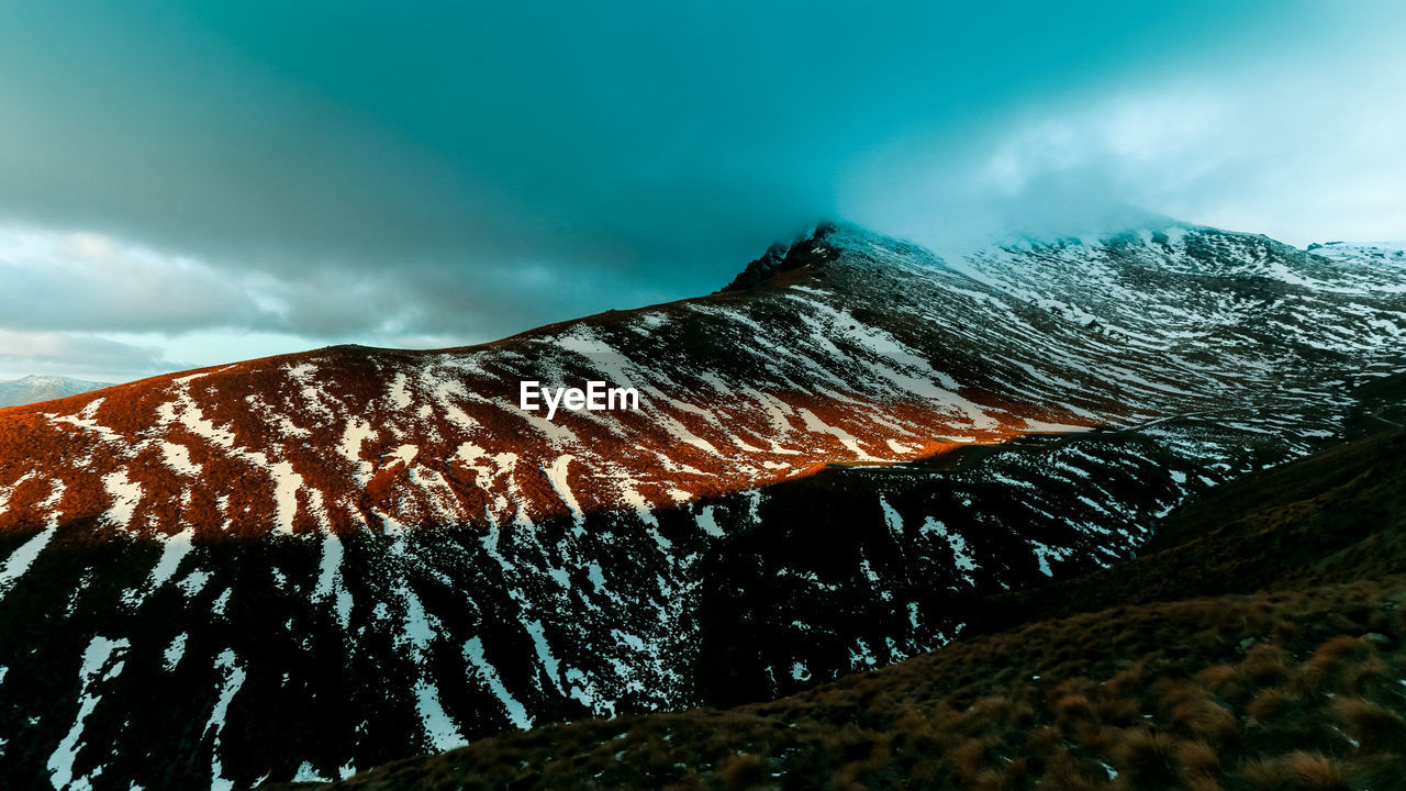 Scenic view of snowcapped mountain against sky