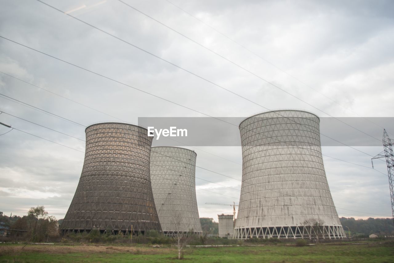 Low angle view of industrial chimney smoke stack against sky