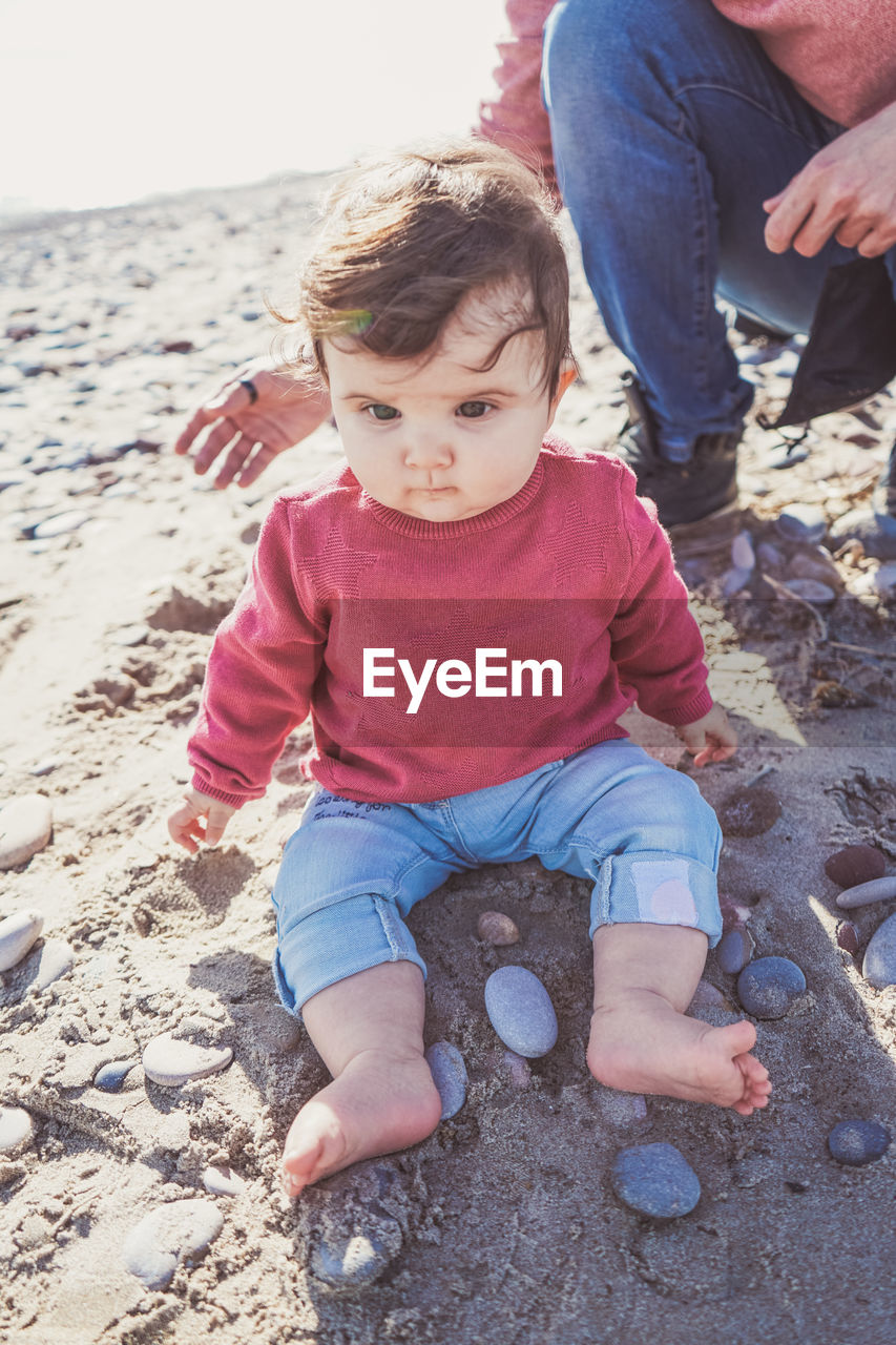 FULL LENGTH OF CUTE BABY GIRL ON BEACH