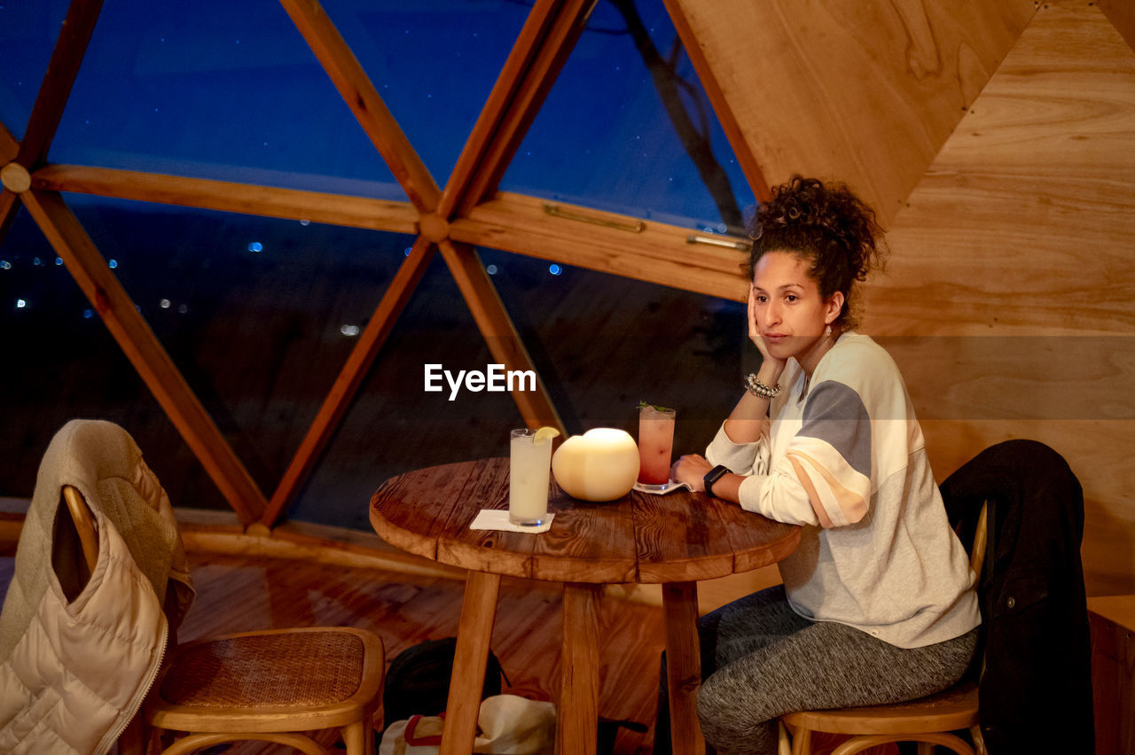 Relaxed woman inside a dome tent.