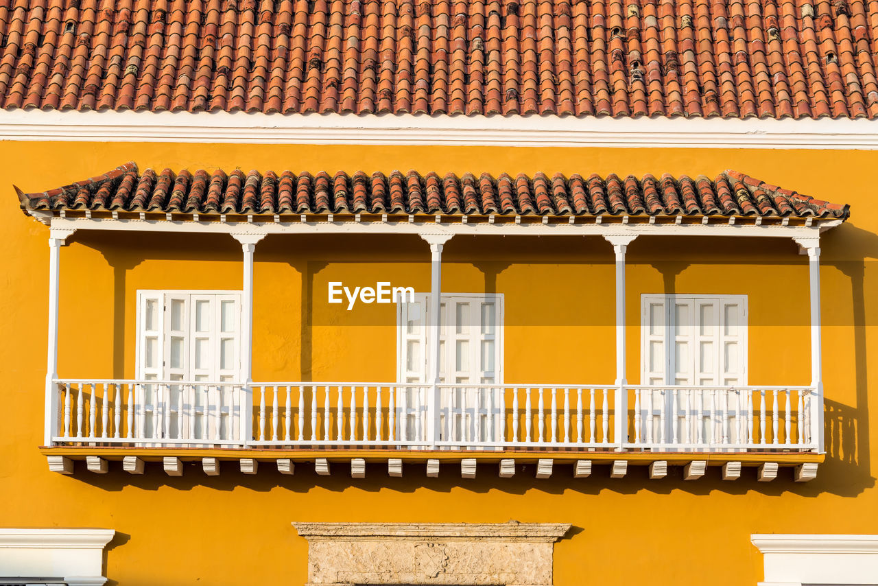 Exterior of yellow house during sunny day