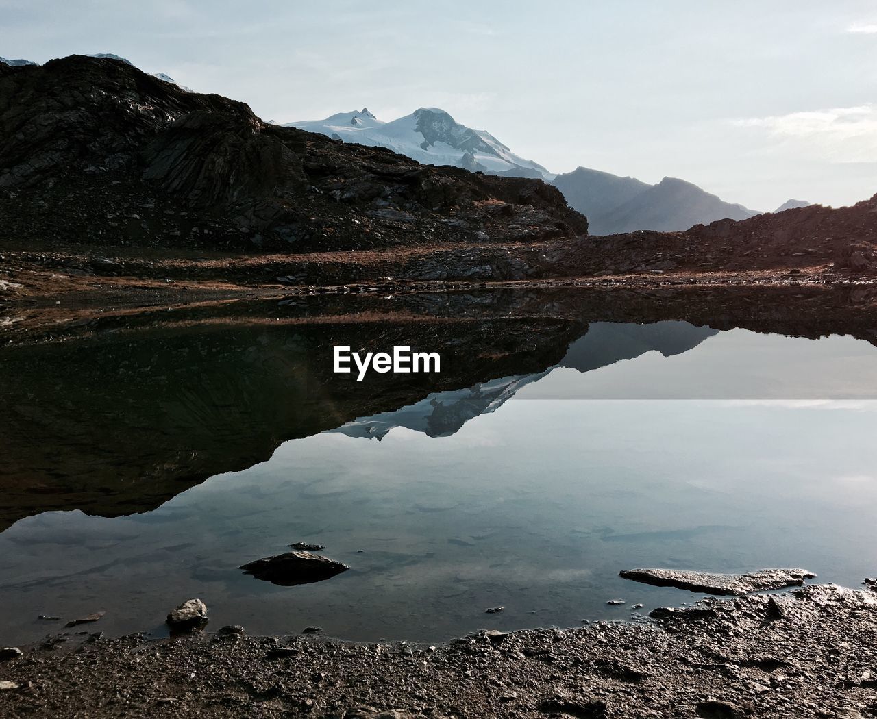 Scenic view of lake and mountains against sky