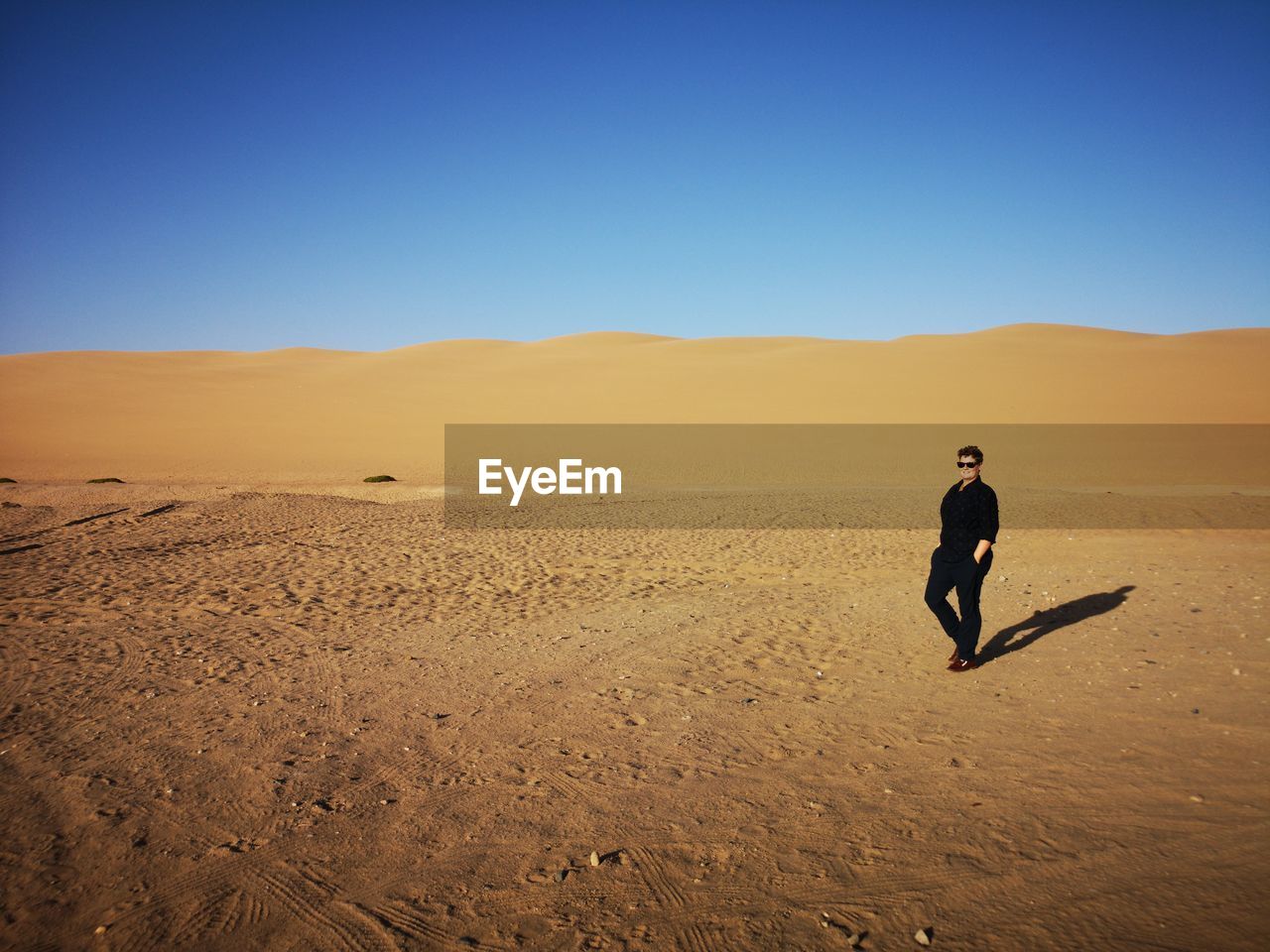 FULL LENGTH OF MAN ON ARID LANDSCAPE