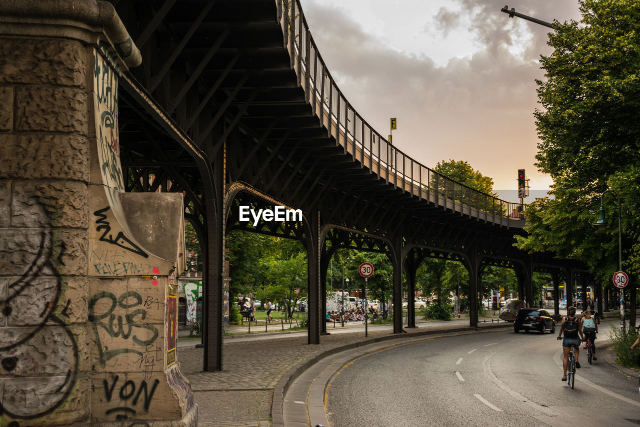 Low angle view of bridge in city against sky