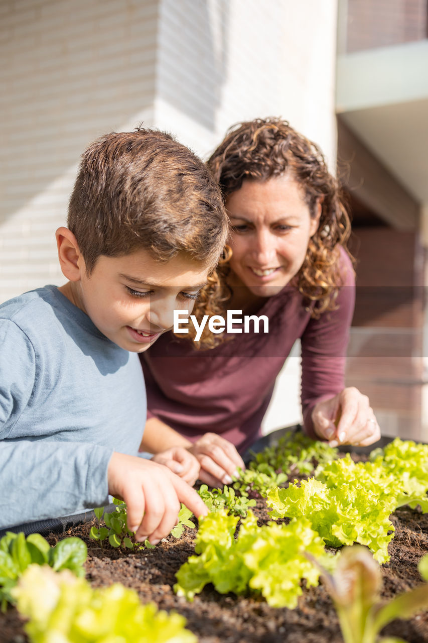 Mother and son working on a urban garden at home