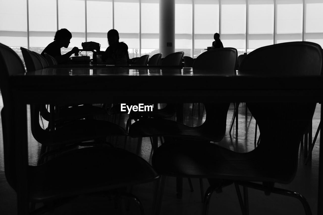 VIEW OF PEOPLE SITTING ON TABLE