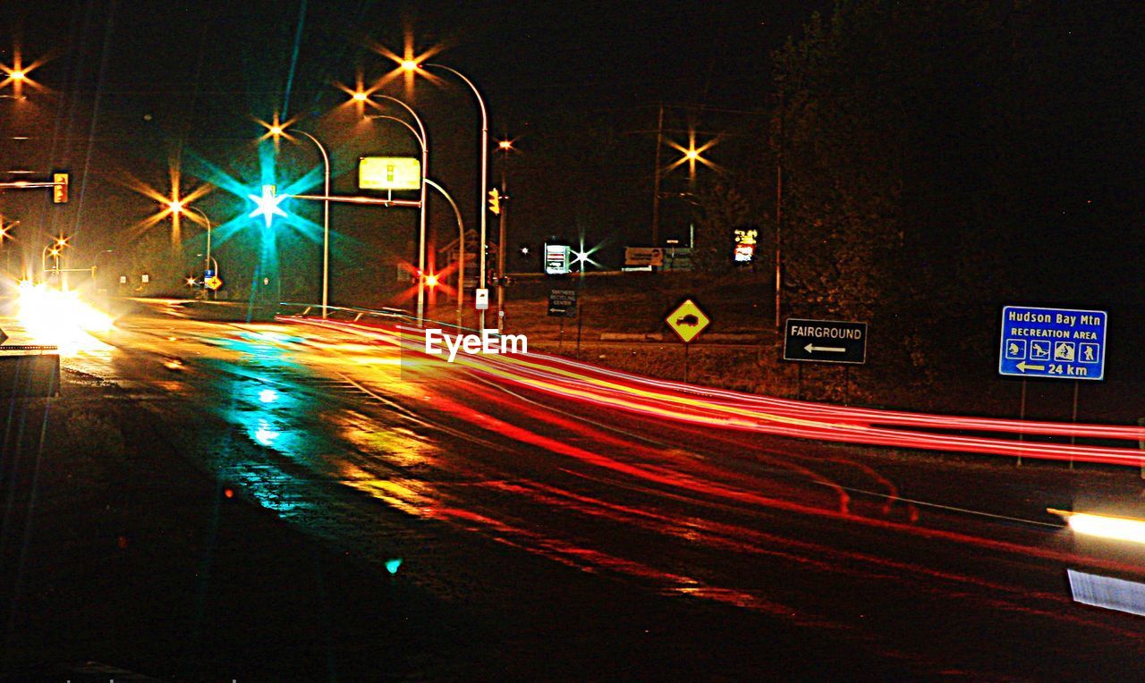 LIGHT TRAILS ON ROAD IN CITY
