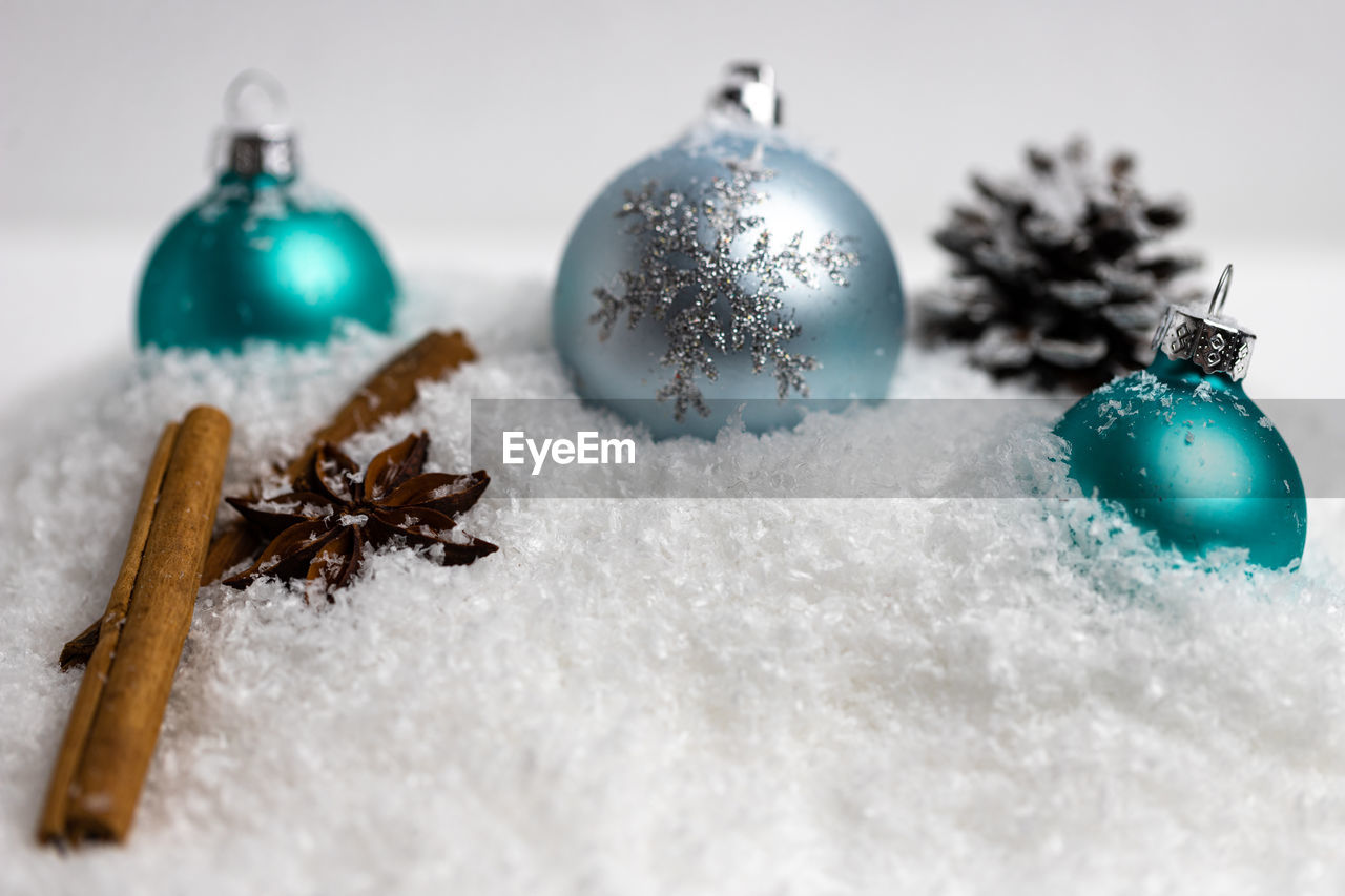 Close-up of baubles on fake snow