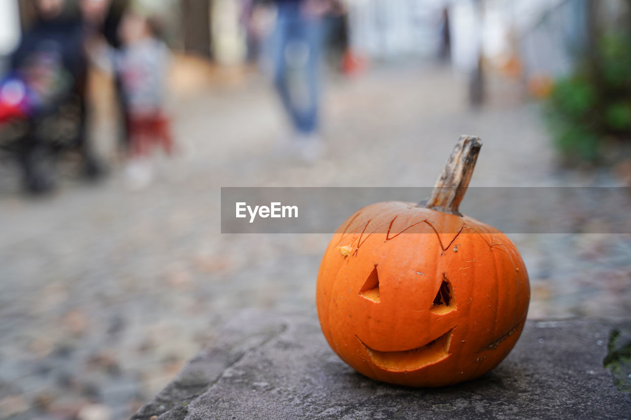 Close-up of pumpkin on road during halloween