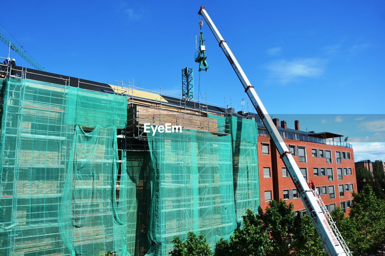LOW ANGLE VIEW OF CONSTRUCTION SITE AGAINST SKY