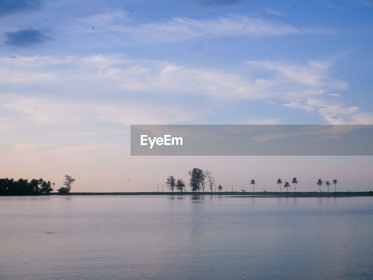 SCENIC VIEW OF LAKE AT SUNSET