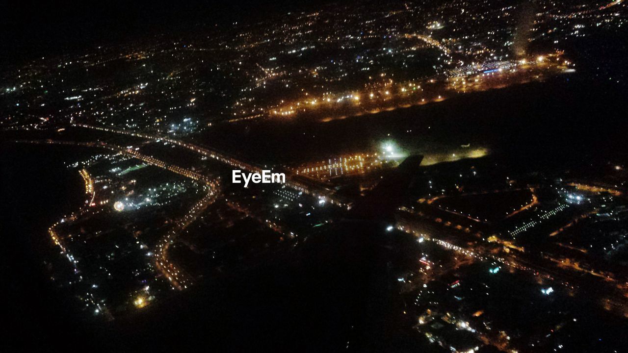 AERIAL VIEW OF ILLUMINATED CITY AT NIGHT