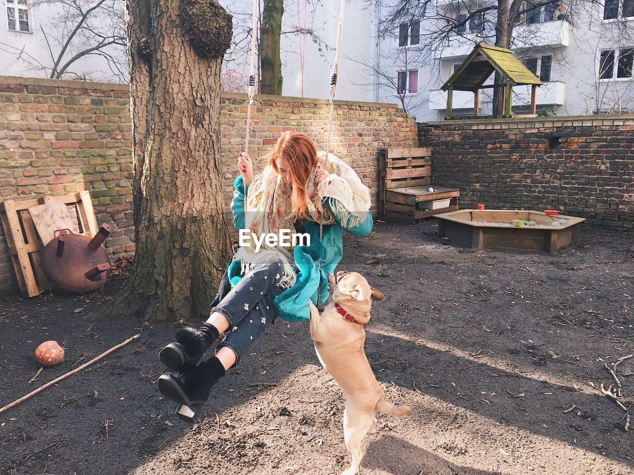 Woman on swing with dog