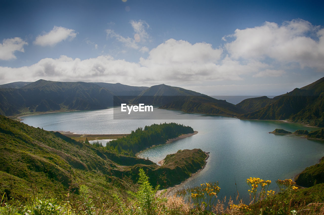 Scenic view of lake and mountains against sky