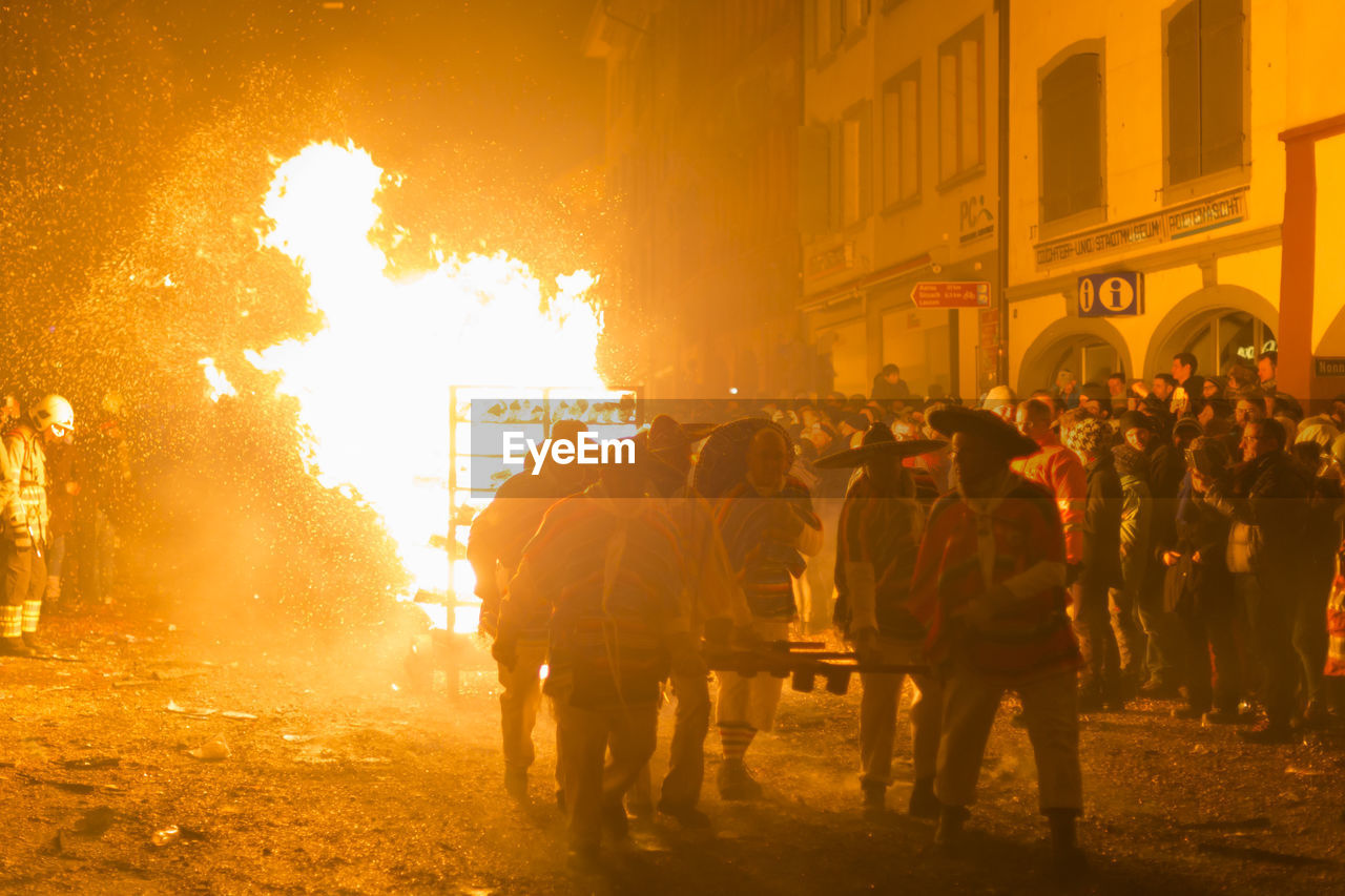 Chienbaese festival. switzerland, liestal, feb 18. participants pulling a wagon with burning wood.