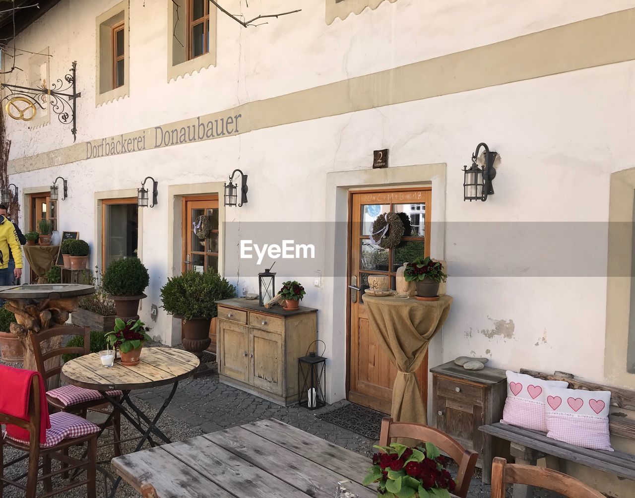 POTTED PLANTS ON TABLE OUTSIDE BUILDING