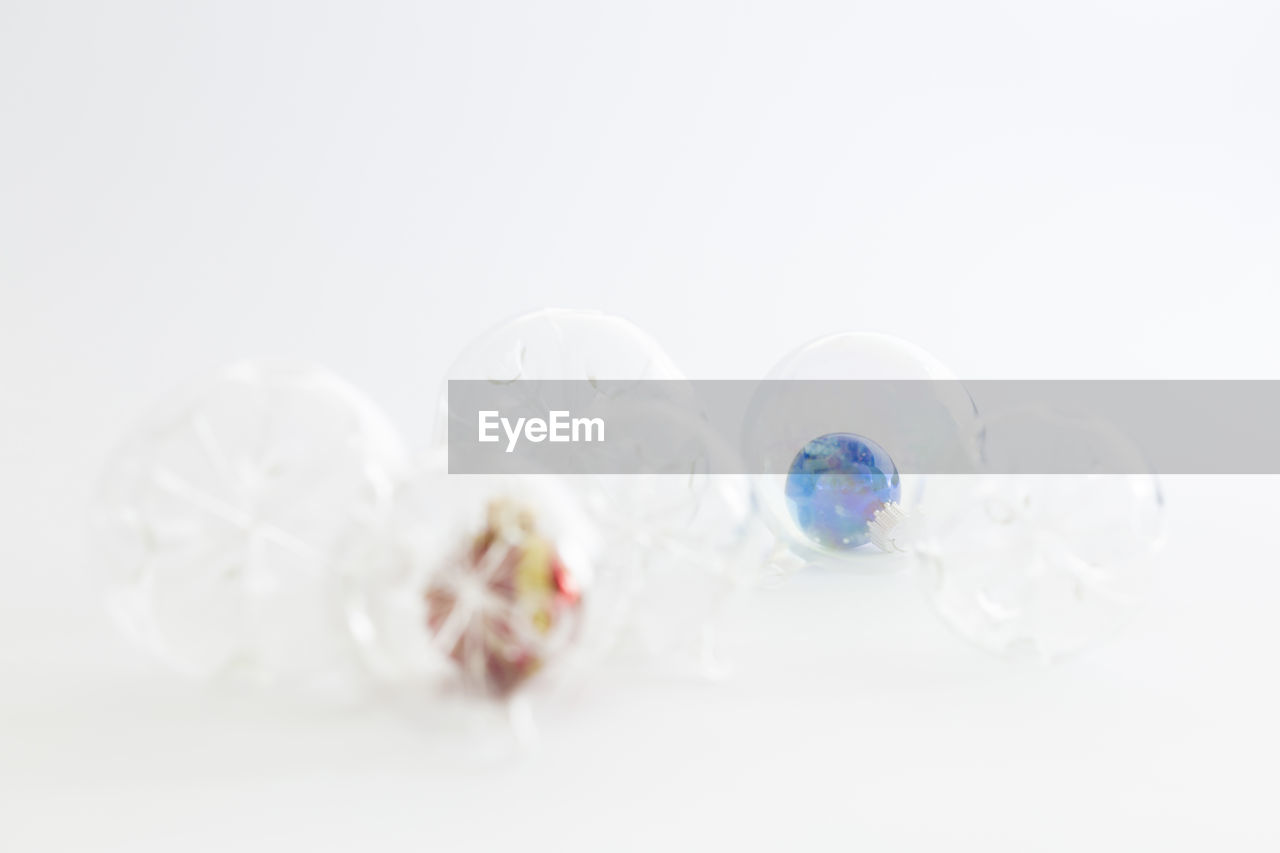 Close-up of crystal balls against white background