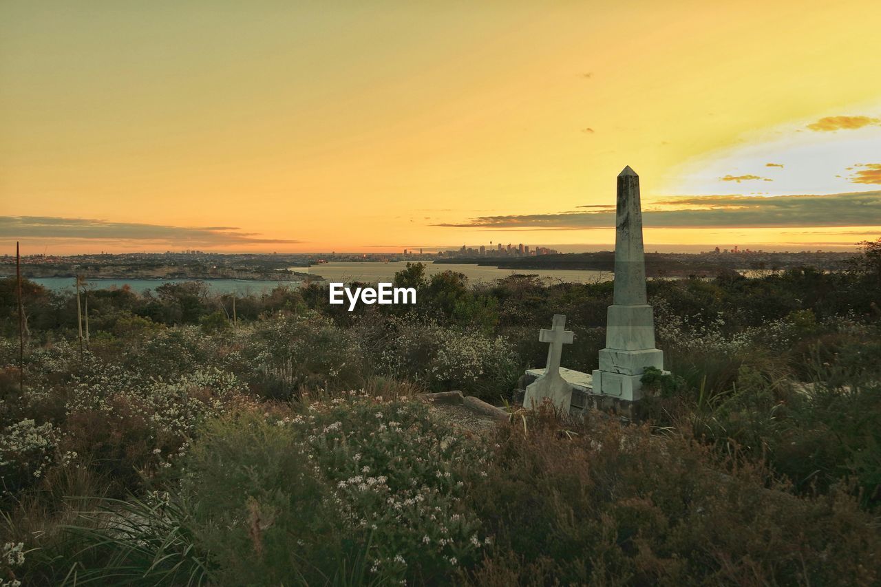 Quarantine station cemetery against river at sunset